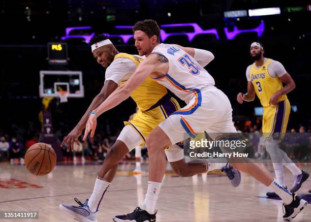 Kent Bazemore of the Los Angeles Lakers and Mike Muscala of the Oklahoma City Thunder reach for a rebound during a 107-104 Oklahoma City Thunder win...
