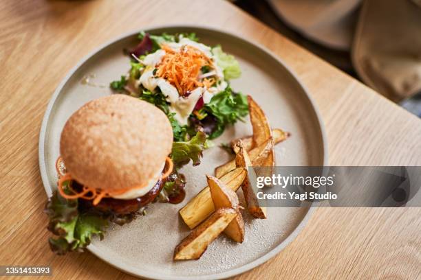 vegan cafe's veggie burger lunch plate. - french fries top view stock pictures, royalty-free photos & images