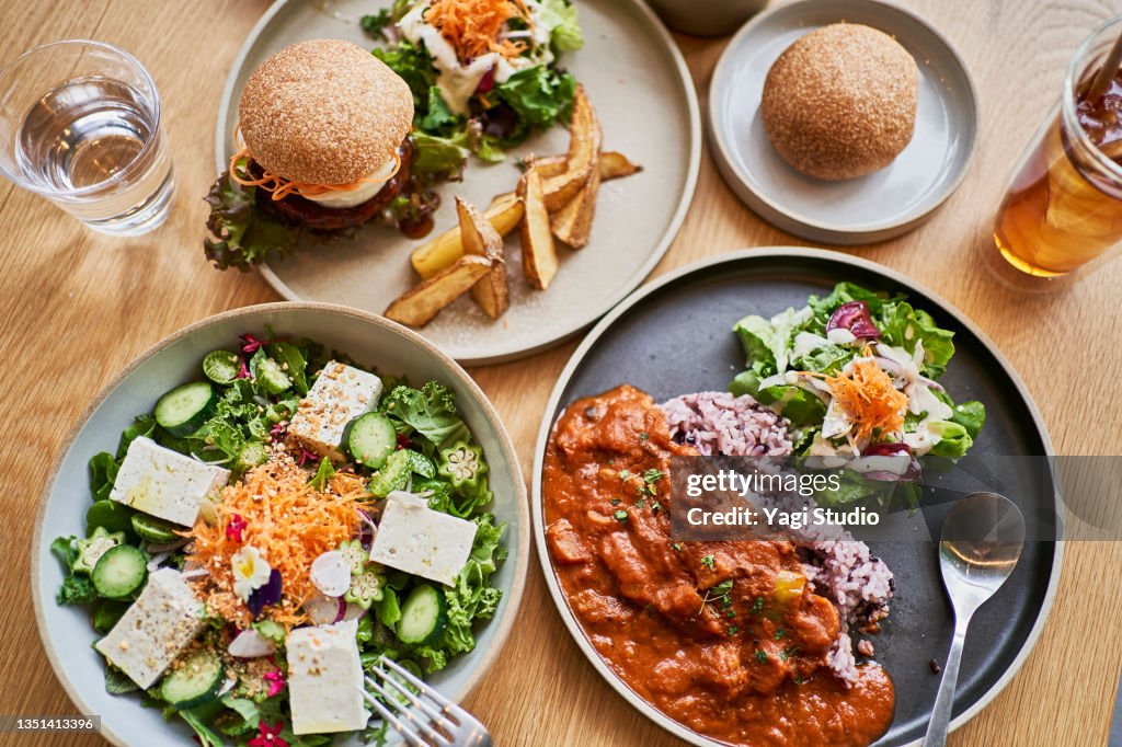 Scene at a table with a couple enjoying lunch at a vegan cafe.