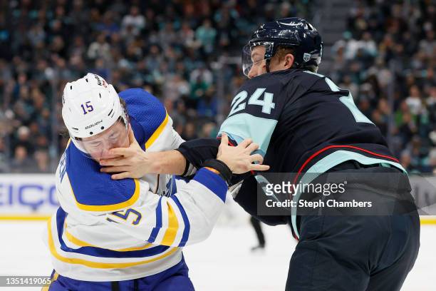 John Hayden of the Buffalo Sabres and Jamie Oleksiak of the Seattle Kraken fight during the first period at Climate Pledge Arena on November 04, 2021...