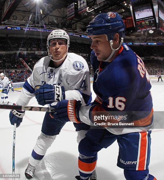 Vincent Lecavalier of the Tampa Bay Lightning moves in to check Marty Reasoner of the New York Islanders at the Nassau Veterans Memorial Coliseum on...