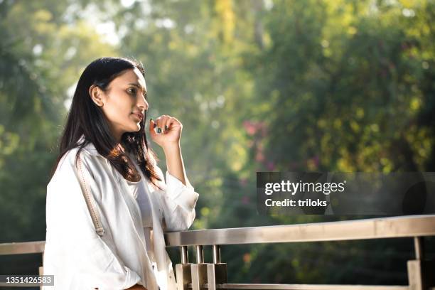 young woman admiring view at balcony - women india partition stock pictures, royalty-free photos & images