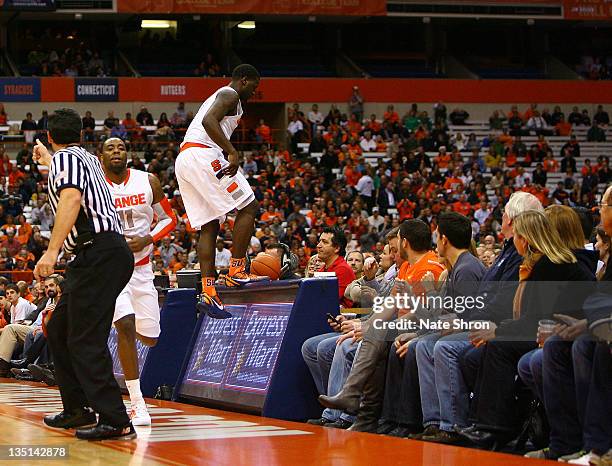 Dion Waiters of the Syracuse Orange steps onto the display board as he runs out of bounds during the game against the Marshall Thundering Herd during...