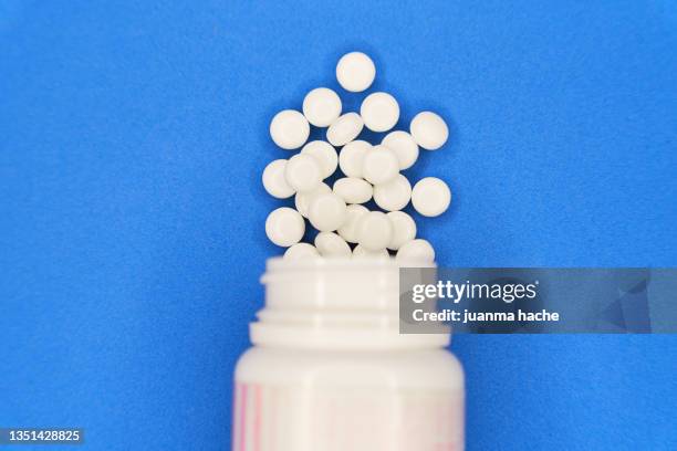 tablets spill out of the plastic container - anti depressant stock pictures, royalty-free photos & images