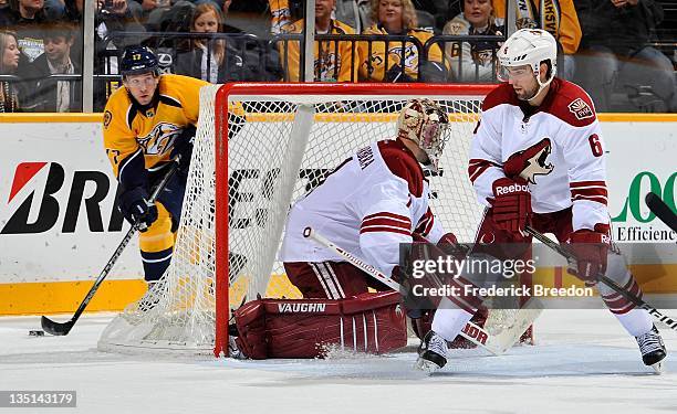 Chris Mueller of the Nashville Predators skates behind the net of goalie Jason LaBarbera of the Phoenix Coyotes at the Bridgestone Arena on December...