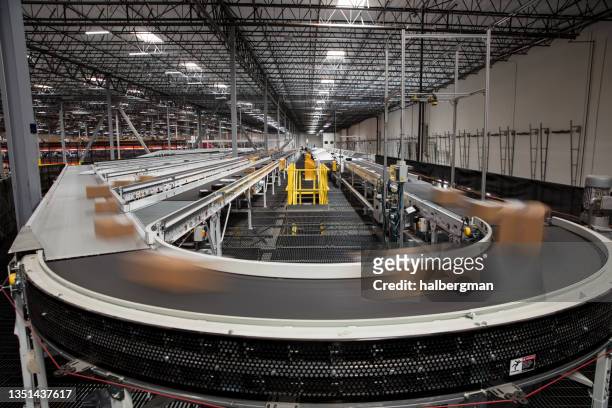 long exposure of packages on conveyor belt - shipping stock pictures, royalty-free photos & images