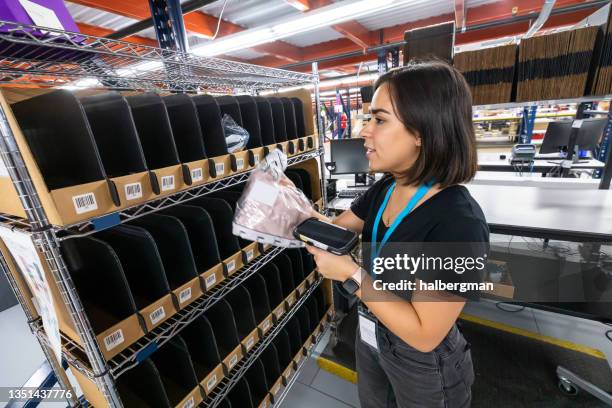 fulfillment center packer pulling item from order picking cart - scanner stock stock pictures, royalty-free photos & images