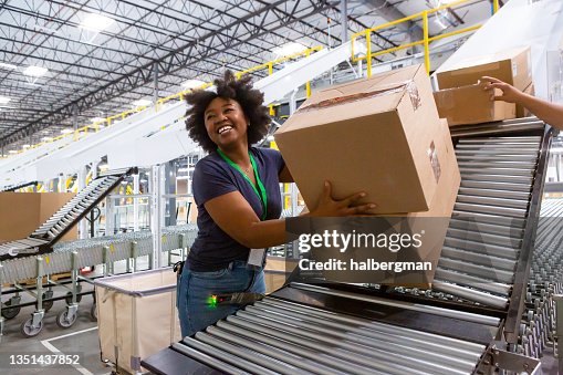 Cheerful Warehouse Employee Loading Boxes Into Truck Cheerful Warehouse Employee Loading Boxes Into Truck