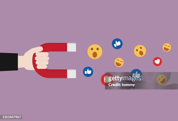 hand hold a magnet to pull an emoticon - marketing technology stock illustrations