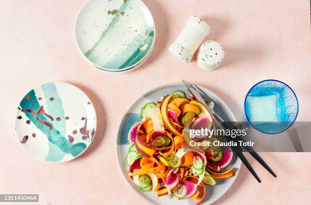 plate of fresh salad on peach background - salt and pepper shakers stock pictures, royalty-free photos & images