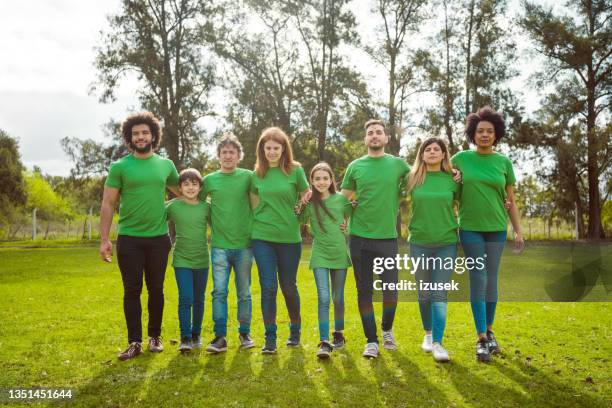 volunteers at park during environmental cleanup - green tee stock pictures, royalty-free photos & images