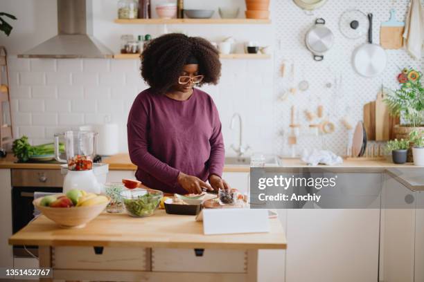 woman preparing fresh fruit smoothie - detox stock pictures, royalty-free photos & images