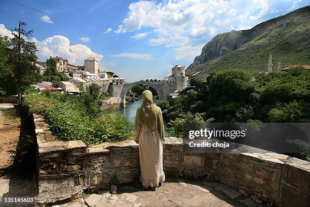 bosnian girl looking at famous old mostar bridge...bosnia and herzegovina - mostar stock pictures, royalty-free photos & images