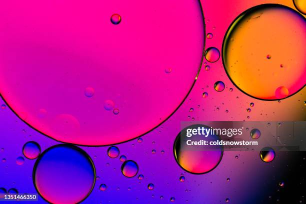 macro oil and water multi colored abstract background - bontgekleurd stockfoto's en -beelden