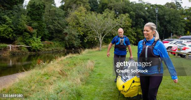 an active couple - carrying kayak stock pictures, royalty-free photos & images