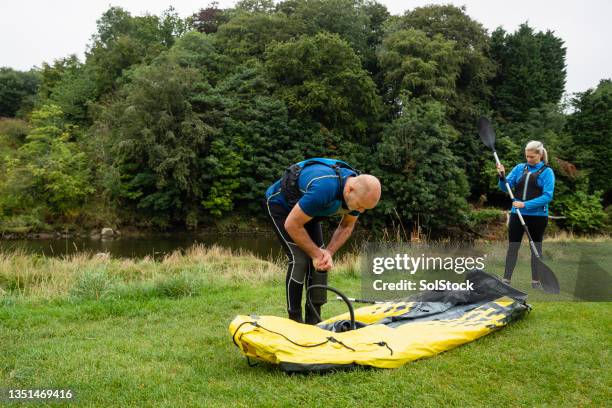 preparing to go kayaking - air pump stock pictures, royalty-free photos & images