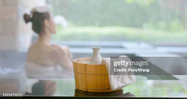 sake and hot spring bath - winter skin stock pictures, royalty-free photos & images