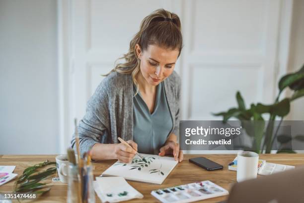 woman at home hobby  painting - relaxation therapy stock pictures, royalty-free photos & images