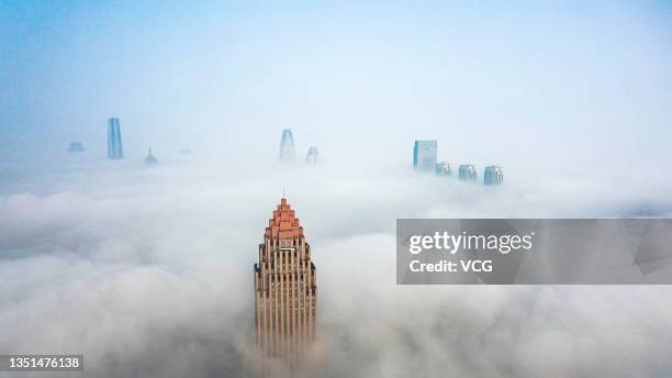 Aerial view of buildings surrounded by dense fog on November 5, 2021 in Tianjin, China.