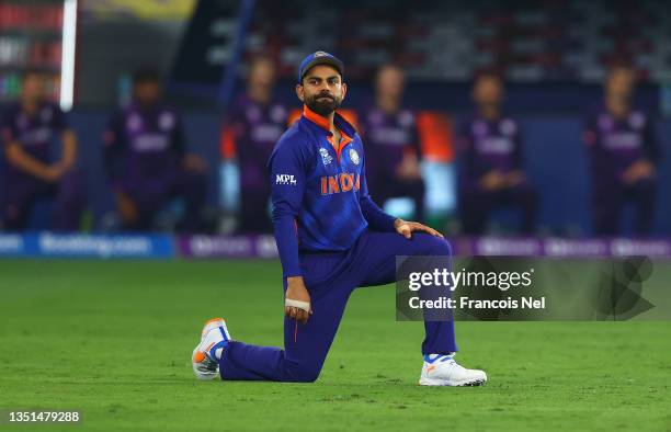 Virat Kolhi of India takes the knee during the ICC Men's T20 World Cup match between India and Scotland at Dubai International Cricket Ground on...