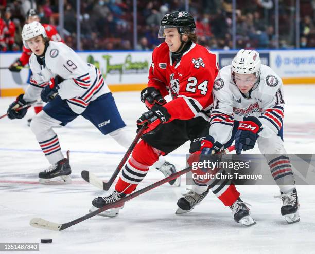 Declan Waddick of the Niagara IceDogs and Matthew Buckley of the Oshawa Generals battle for the puck at Tribute Communities Centre on October 22,...