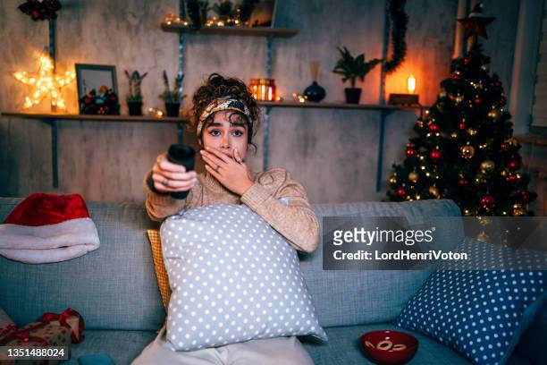 woman scared by horror movie - woman watching horror movie stock pictures, royalty-free photos & images