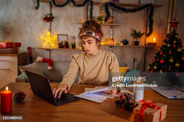 woman managing finances in the evening - christmas budget stock pictures, royalty-free photos & images