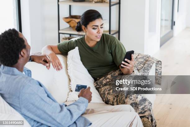 couple making online purchase - army wife stock pictures, royalty-free photos & images