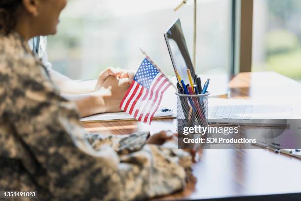 female soldier waits to meet with loan officer - military spouse stock pictures, royalty-free photos & images