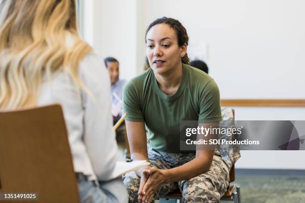 soldier talks with counselor at military counseling center - veteran stock pictures, royalty-free photos & images