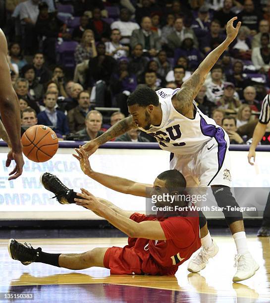 Texas Tech's Ty Nurse passes the ball away from Texas Christian's Hank Thorns, top right, on Tuesday, December 6 at Daniel-Meyer Coliseum in Fort...