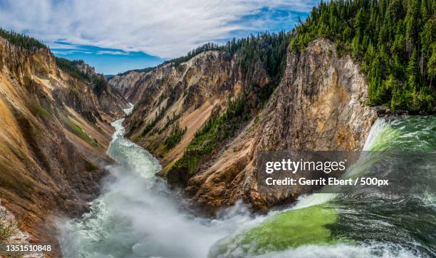 scenic view of waterfall against sky,yellowstone national park,wyoming,united states,usa - yellowstone nationalpark stock-fotos und bilder