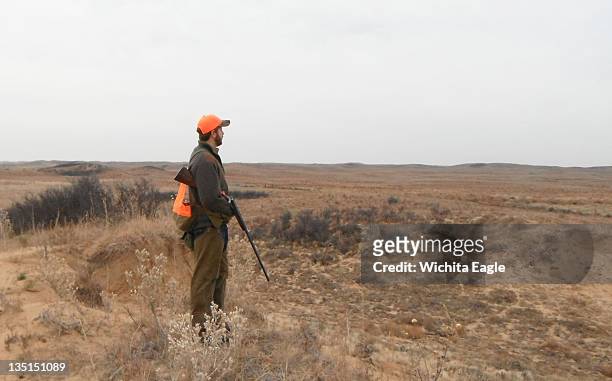 Rehan Nana looks out over ideal lesser prairie chicken habitat, November 23 in Edwards County, Kansas. The main tactic for hunting the birds is...