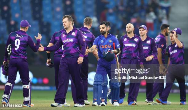 Players of India and Scotland shake hands following the ICC Men's T20 World Cup match between India and Scotland at Dubai International Cricket...