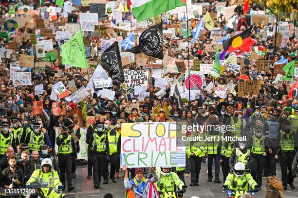 Demonstrators join the Fridays For Future march on November 05, 2021 in Glasgow, Scotland. Day Six of the 2021 climate summit in Glasgow will focus...