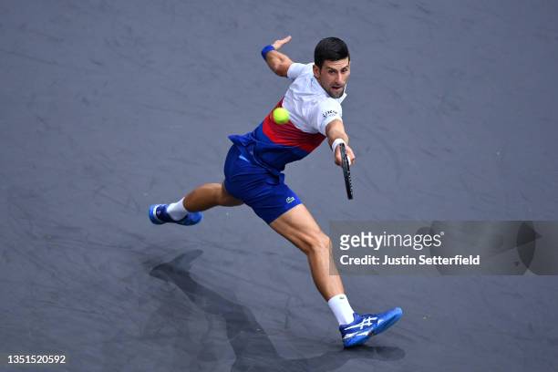 Novak Djokovic of Serbia plays a backhand during his singles match against Taylor Fritz of the United States during Day Five of the Rolex Paris...