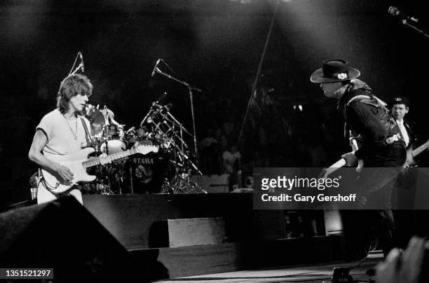 View of Rock and Blues musicians Jeff Beck and Stevie Ray Vaughan as they perform onstage, with Vaughan's band Double Trouble, during 'The Fire Meets...