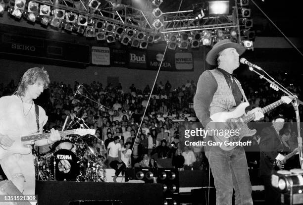 View of Rock and Blues musicians Jeff Beck and Stevie Ray Vaughan as they perform onstage, with Vaughan's band Double Trouble, during 'The Fire Meets...