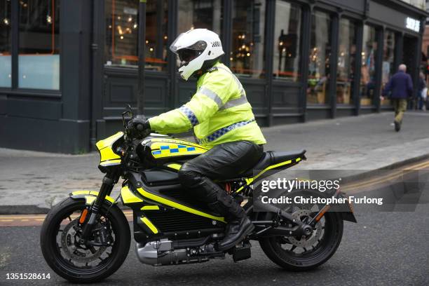 Police officer on an electric motorcycle escorts the "Fridays For Future" climate rally during COP26 on November 5, 2021 in Glasgow, Scotland. Day...