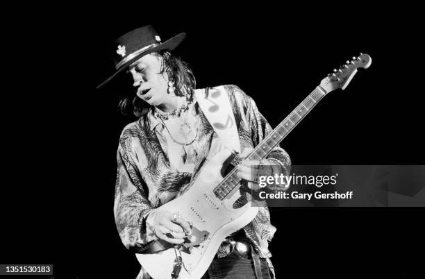 American Blues and Rock musician Stevie Ray Vaughan plays guitar as he performs onstage during the 'Soul to Soul' tour at Pier 90, New York, New...
