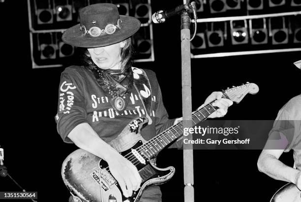 American Blues and Rock musician Stevie Ray Vaughan plays guitar as he performs onstage, with his band Double Trouble, during the 'Texas Flood' tour...