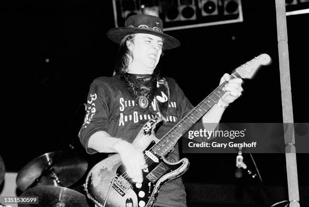 American Blues and Rock musician Stevie Ray Vaughan plays guitar as he performs onstage, with his band Double Trouble, during the 'Texas Flood' tour...