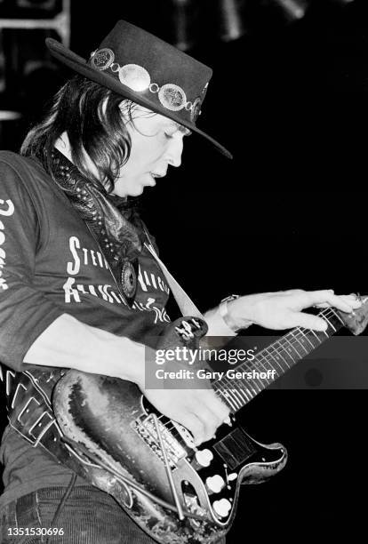 American Blues and Rock musician Stevie Ray Vaughan plays guitar as he performs onstage, with his band Double Trouble, during the 'Texas Flood' tour...