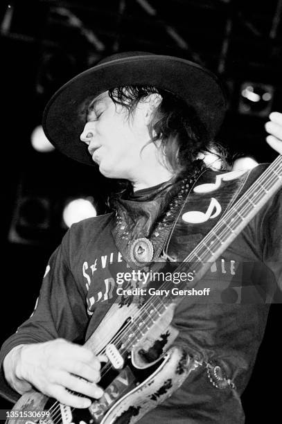 American Blues and Rock musician Stevie Ray Vaughan plays guitar as he performs onstage, with his band Double Trouble, during the 'Texas Flood' tour...