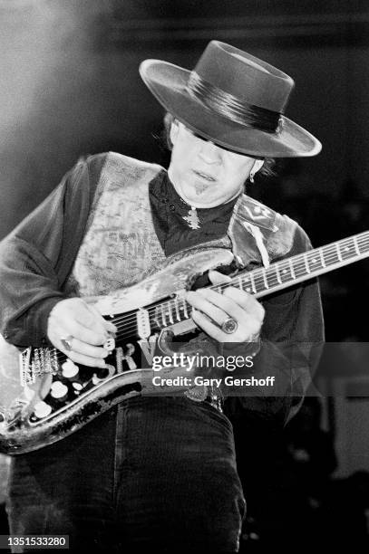 American Blues and Rock musician Stevie Ray Vaughan plays guitar as he performs onstage, with his band Double Trouble, during 'The Fire Meets the...