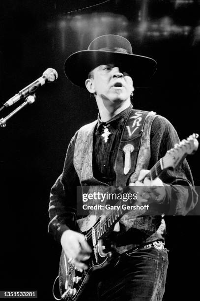 American Blues and Rock musician Stevie Ray Vaughan plays guitar as he performs onstage, with his band Double Trouble, during 'The Fire Meets the...