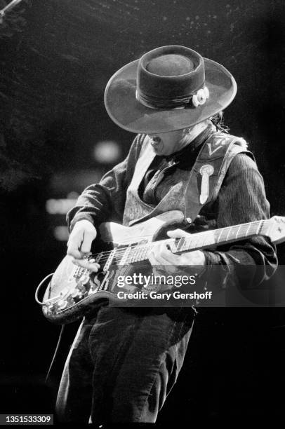 American Blues and Rock musician Stevie Ray Vaughan plays guitar as he performs onstage, with his band Double Trouble, during 'The Fire Meets the...