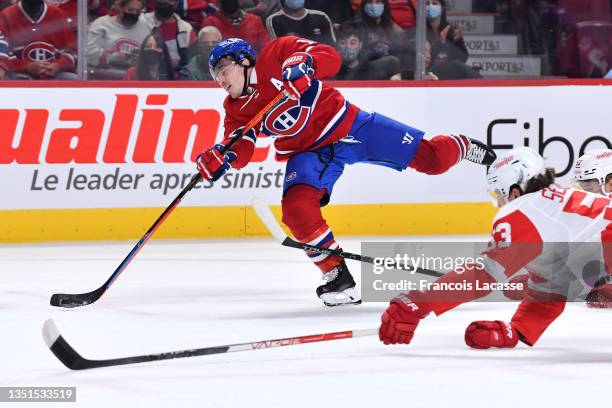Brendan Gallagher of the Montreal Canadiens fires a shoth while Moritz Seider of the Detroit Red Wings slides to try to block it in the NHL game at...