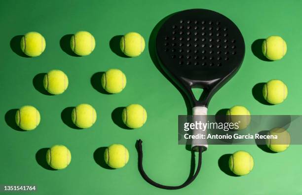 paddle tennis objects on green background in studio image, hard flash light effect - formal ball stock pictures, royalty-free photos & images