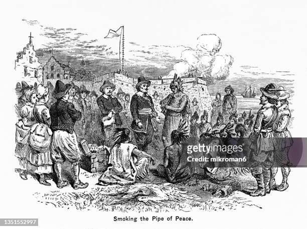 old engraved illustration of indians and colonists smoking a pipe of peace - pfeife natur stock-fotos und bilder
